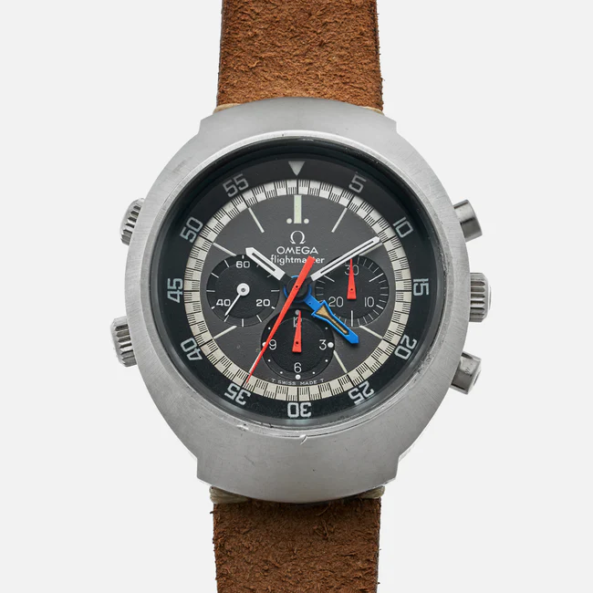 A round Omega Flightmaster 145.026 wristwatch with a black dial, multiple colored hands, three subdials, and a brown leather strap. The metal case features four pushers and a rotating bezel marked in minutes.