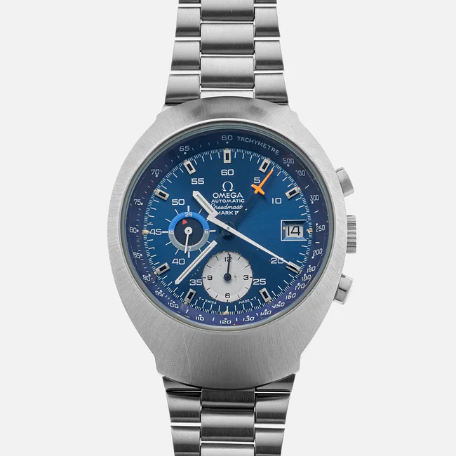 A stainless steel Omega Speedmaster Mark III 176.002 wristwatch with a blue dial, silver hour markers, three subdials, a date window at 3 o’clock, and a tachymeter scale, shown on a matching metal bracelet.