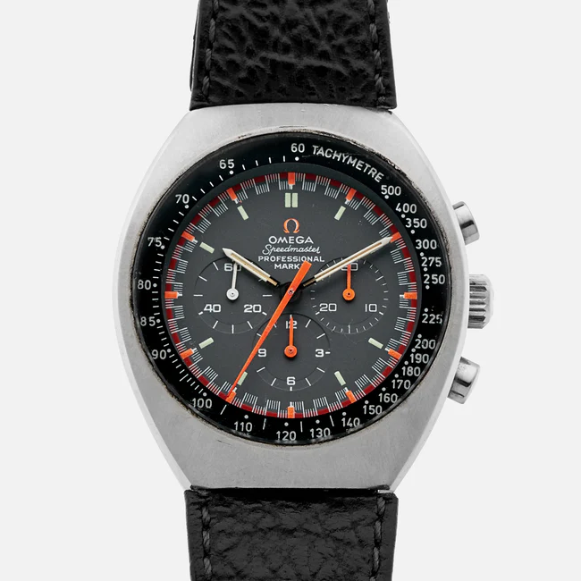 A close-up of an Omega Speedmaster Mark ii 145.014 wristwatch with a black dial, orange accents, three subdials, tachymeter scale, and a black leather strap. The watch features two pushers and a crown on the right side.