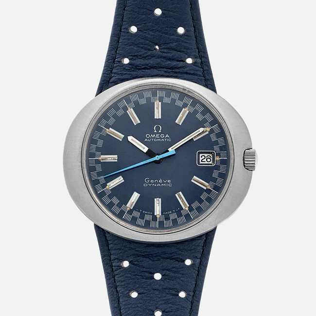 A blue Omega Dynamic 135.033 Genève automatic wristwatch with a round stainless steel case, blue dial, silver hour markers, a date window at 3 o’clock, and a blue perforated leather strap.