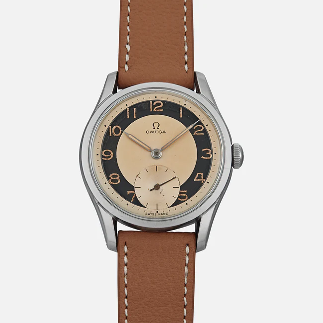 A wristwatch with a brown leather strap, silver case, and a cream and black dial featuring gold Arabic numerals, the Omega logo, and a small seconds subdial at 6 o’clock—this is the classic Omega Seamaster 2937.