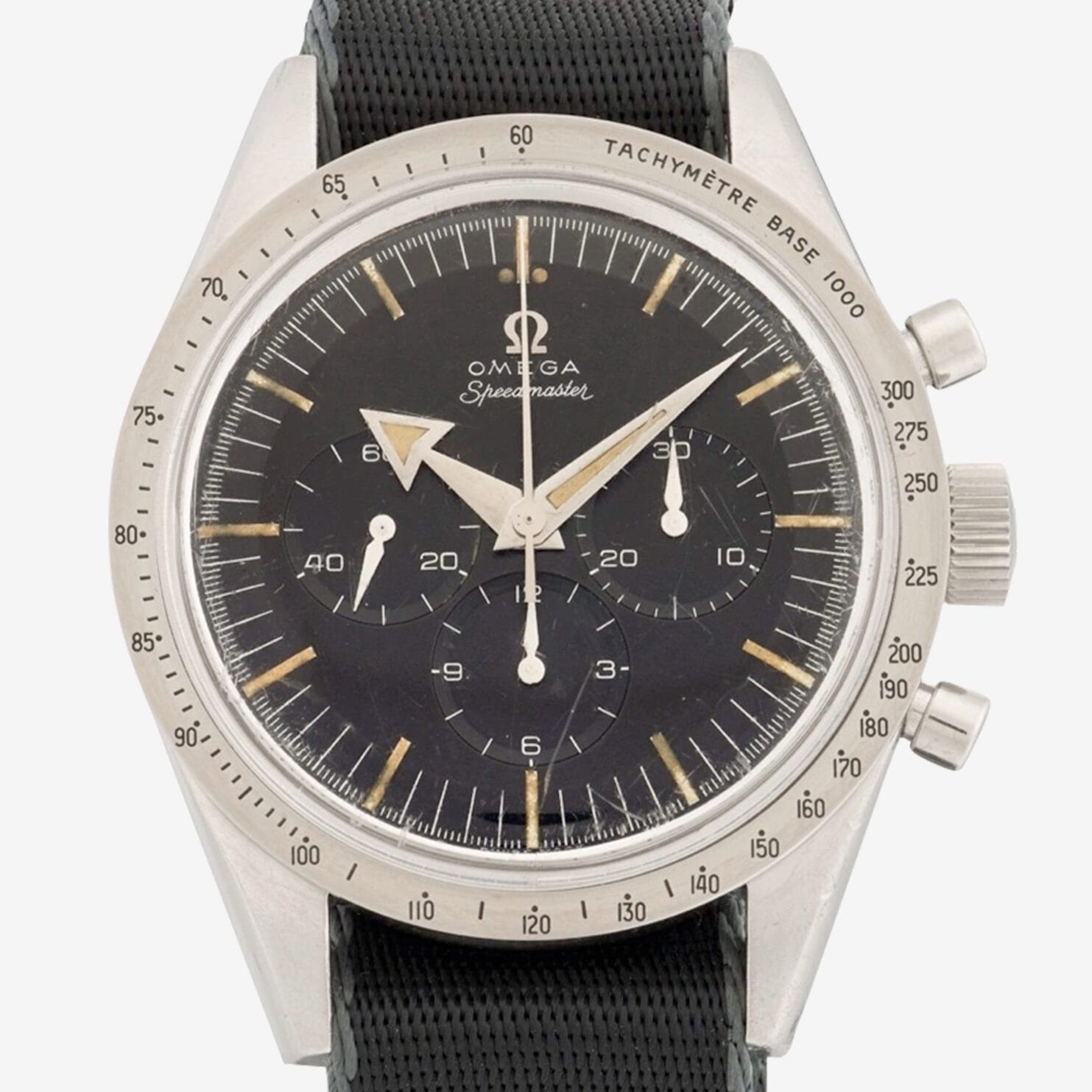 A vintage Omega Speedmaster 2915 wristwatch with a black dial, three subdials, silver hour markers, and a tachymeter scale on the bezel, shown with a black textured strap.