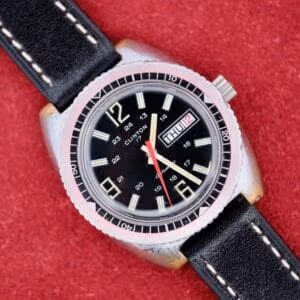 Clinton World Timer on black leather strap, full top-down view of 39mm steel-tone case and black dial