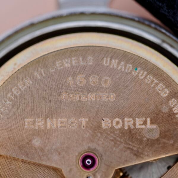 Close-up of the Ernest Borel Incastar 1560 Gold Capped watch movement, engraved with ERNEST BOREL, 1560 PATENTED, and SEVENTEEN 17 JEWELS UNADJUSTED SWISS; a single jewel appears near the bottom center.