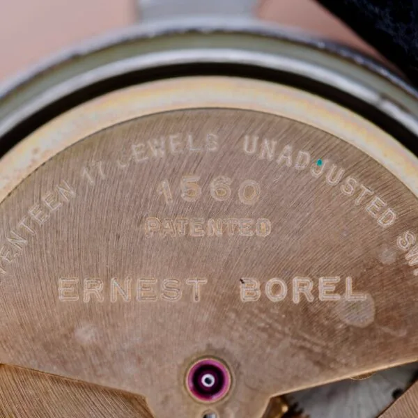 Close-up of the Ernest Borel Incastar 1560 Gold Capped watch movement, engraved with ERNEST BOREL, 1560 PATENTED, and SEVENTEEN 17 JEWELS UNADJUSTED SWISS; a single jewel appears near the bottom center.