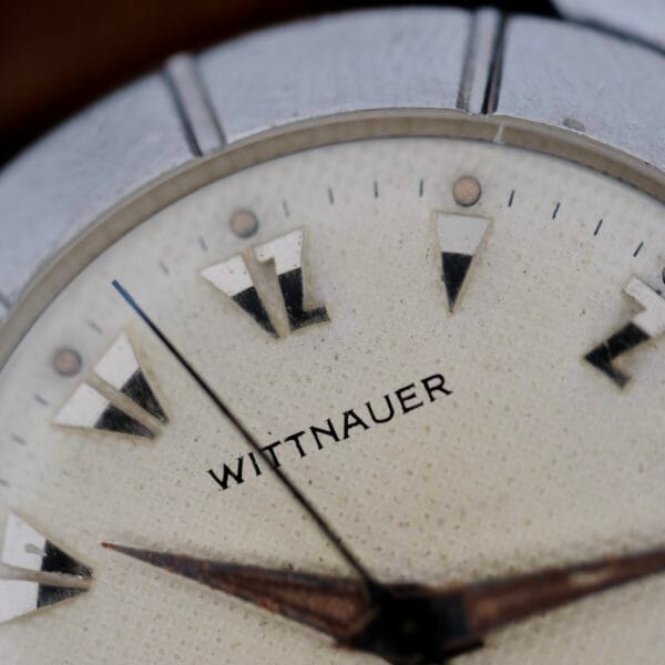 Close-up of the Wittnauer 2065 Waffle Dial showcasing the brand name, textured off-white waffle dial, Art Deco indicies, and dark hands.