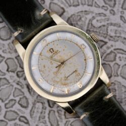 An Omega Seamaster Automatic 2577-17 Tropic Dial wristwatch with a worn dial and dark leather strap displayed on a patterned background.