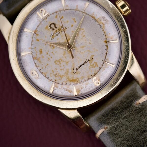 Close-up of an Omega Seamaster Automatic 2577-17 with a worn tropic dial and classic leather strap.