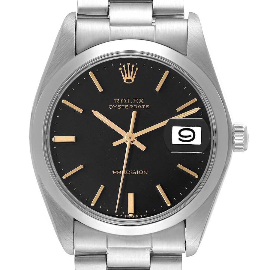 A stainless steel Rolex Oysterdate 6694 wristwatch with a black dial, gold hour markers and hands, a date window at 3 o’clock with magnifier, and a metal link bracelet.