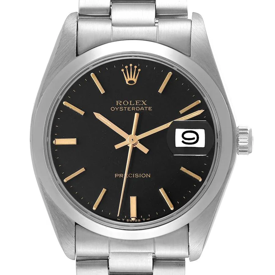 A stainless steel Rolex Oysterdate 6694 wristwatch with a black dial, gold hour markers and hands, a date window at 3 o’clock with magnifier, and a metal link bracelet.