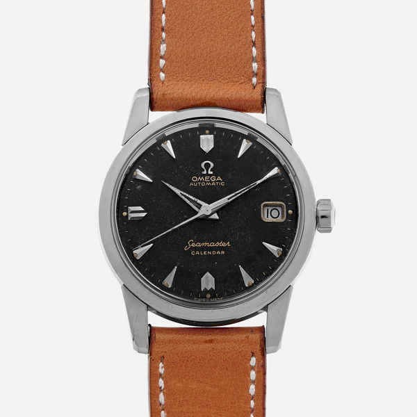 A vintage Omega Seamaster 2849 Calendar wristwatch with a black dial, silver hour markers, date window at 3 o’clock, silver case, and brown leather strap against a plain background.