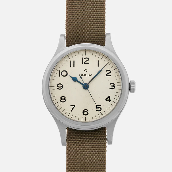 A vintage Omega 6B/159 wristwatch with a beige dial, black Arabic numerals, blue hands, and a brown fabric strap, shown against a plain white background.