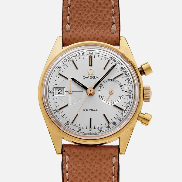 A gold Omega De Ville 146.017 wristwatch with a white dial, two subdials, a date window at 9 oclock, and a brown leather strap. Features include black and gold hour markers and a tachymeter scale.