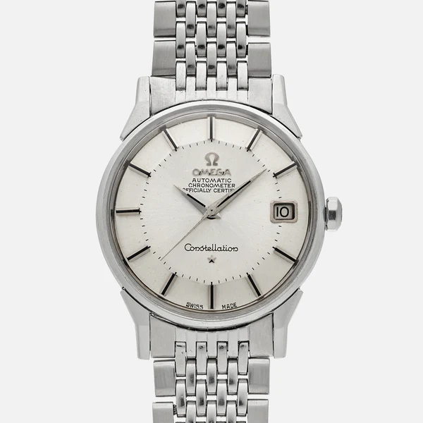 A stainless steel Omega Constellation wristwatch with a silver dial, black hour markers, date window at 3 o’clock, and a metal link bracelet. The face reads Omega Automatic Chronometer Officially Certified.