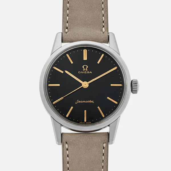 A wristwatch with a black face, gold hour markers and hands, the Omega logo, and the word Seamaster in script. The Omega Seamaster 14390 features a silver case and a light brown leather strap with visible stitching.