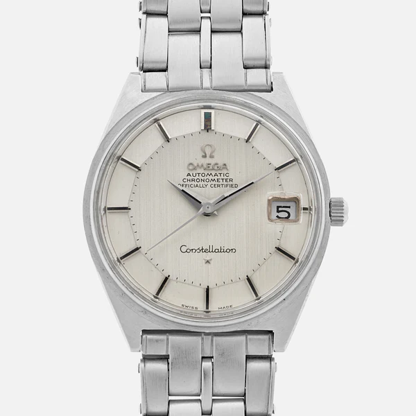 A silver Omega Constellation 168.025 automatic chronometer wristwatch with a metal band, round white dial, stick hour markers, date window at 3 o’clock, and “Constellation” above 6 o’clock.