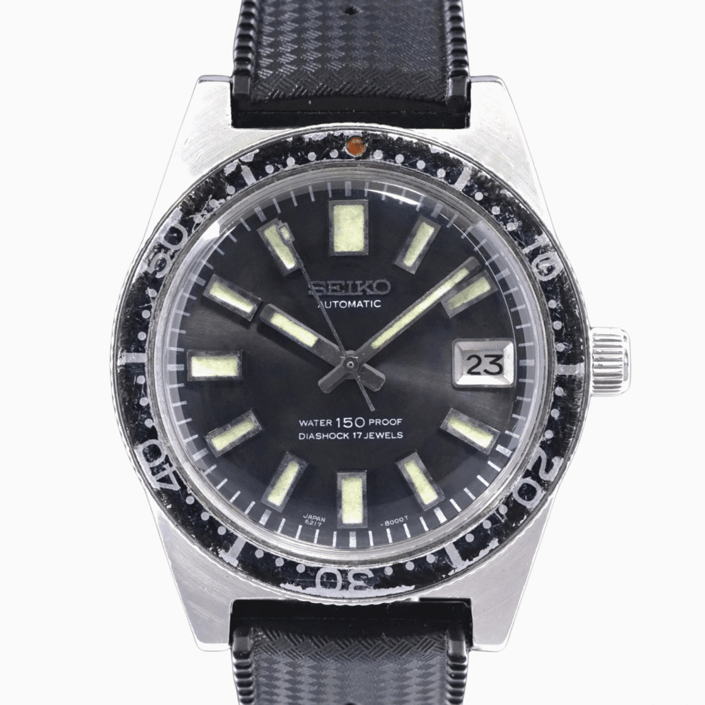 Vintage Seiko 62MAS automatic wristwatch, model 6217-8000, with black strap, luminous markers, and date display showing 23.