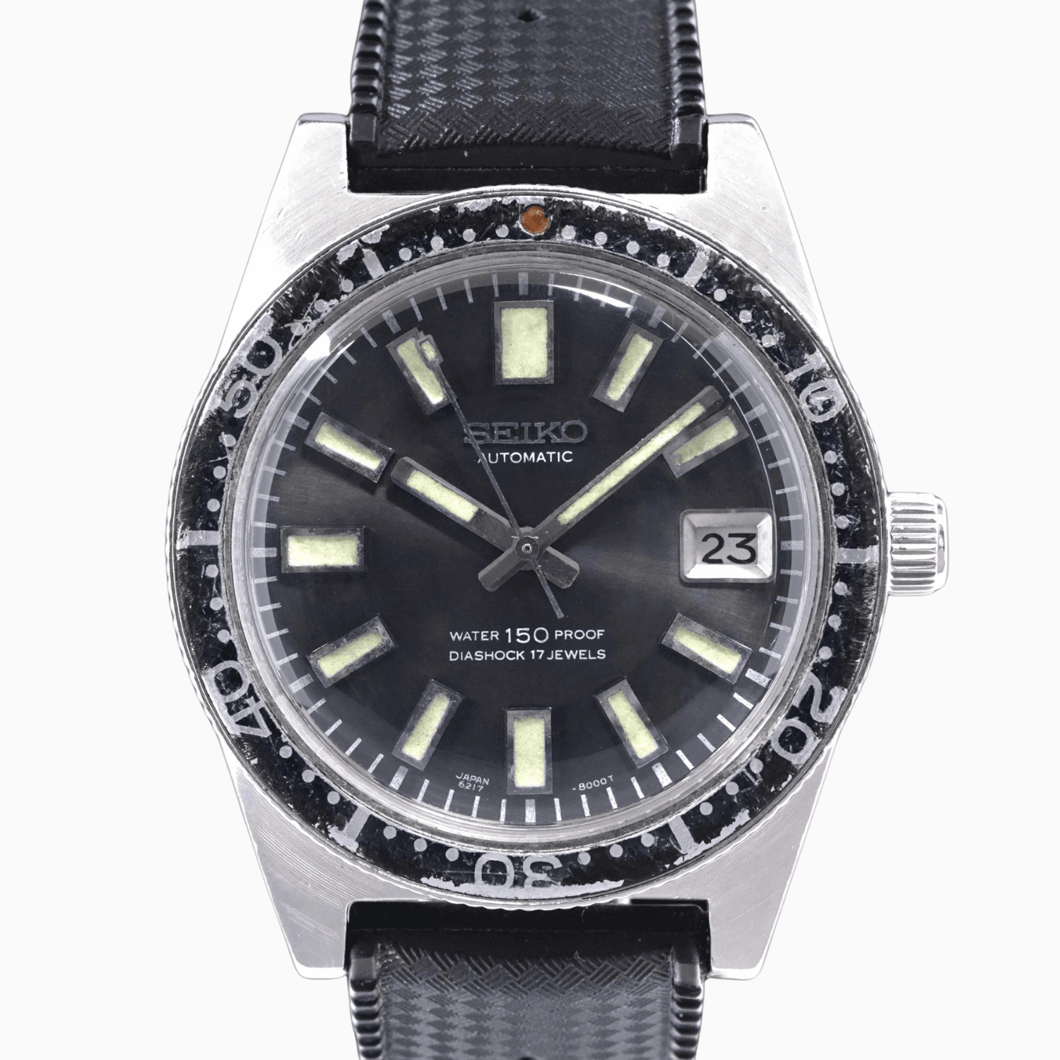 Vintage Seiko 62MAS automatic wristwatch, model 6217-8000, with black strap, luminous markers, and date display showing 23.