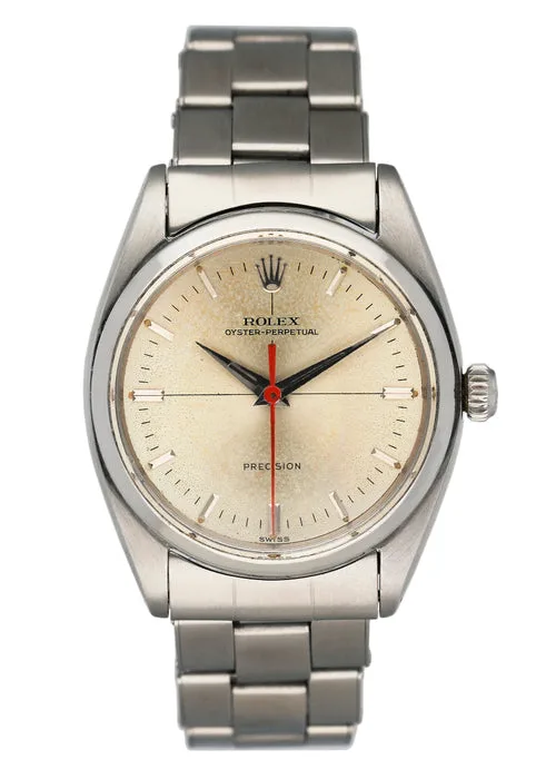 A vintage Rolex Oyster Perpetual Precision watch, reminiscent of the iconic Rolex 6556, featuring a silver bracelet and cream dial.