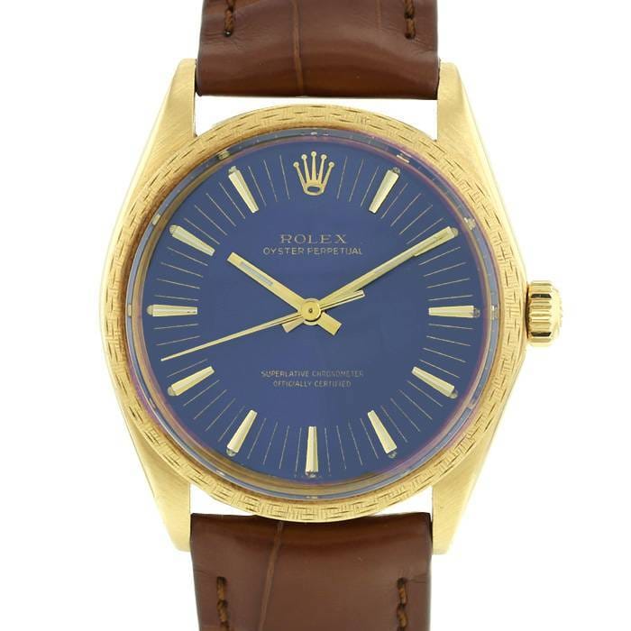 Gold Rolex Oyster Perpetual 1036 watch with a blue dial and brown leather strap, viewed from above.