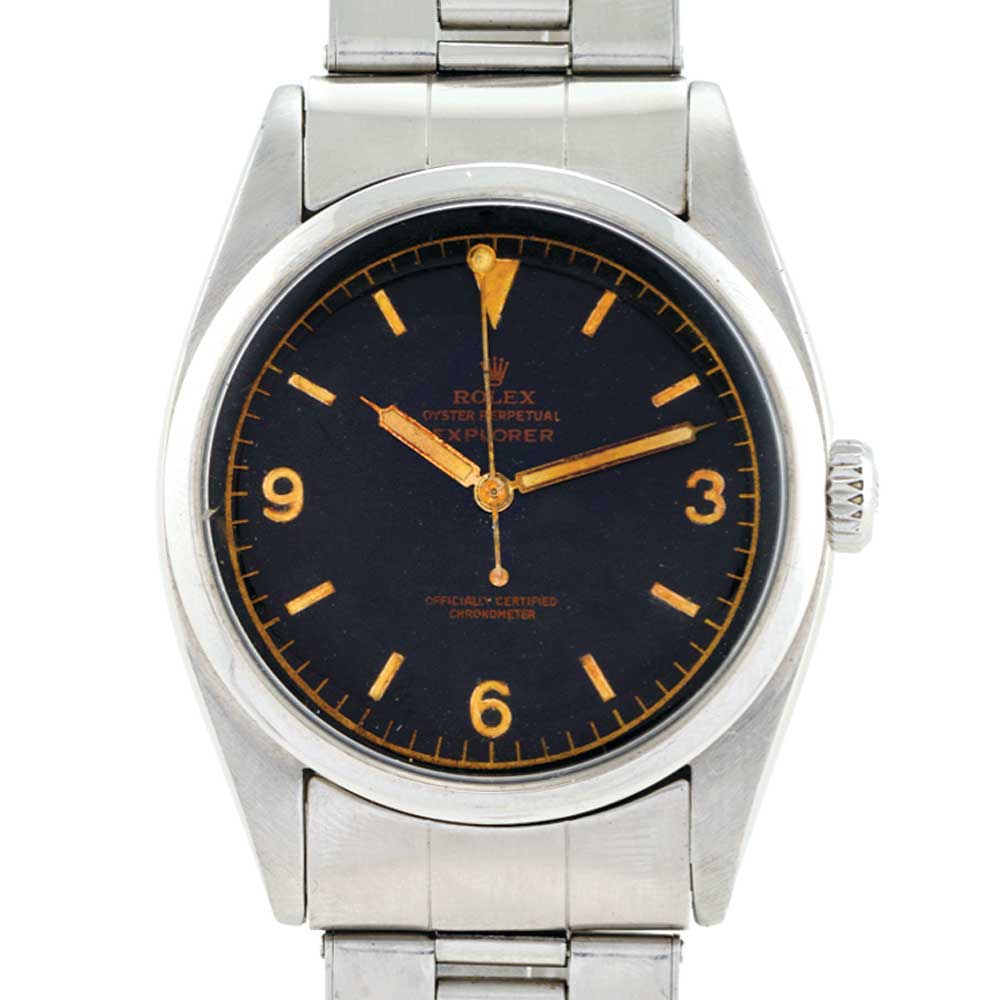 A vintage Rolex Explorer 6350 wristwatch featuring a black dial, silver case, and sleek silver metal band.