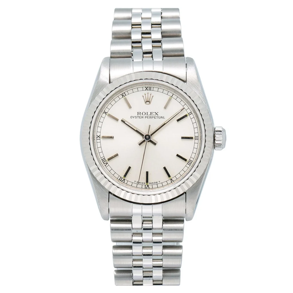 Silver Rolex Oyster Perpetual watch, model 67514, featuring a white dial with Roman numerals and a sleek metal link bracelet.