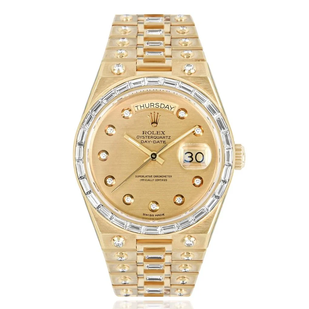 Gold Rolex Oysterquartz Day-Date watch with diamond hour markers, a baguette diamond bezel, and day-date display on the face. Model 19168.