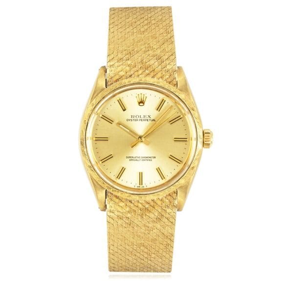 Gold Rolex Oyster Perpetual wristwatch, model 1035, featuring a textured gold band and elegant gold dial.