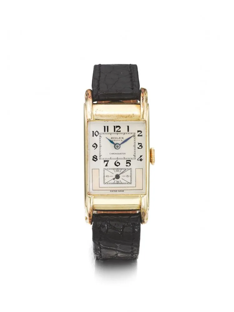 A rectangular gold Rolex Prince wristwatch with a white face, black numbers, and a black leather strap.