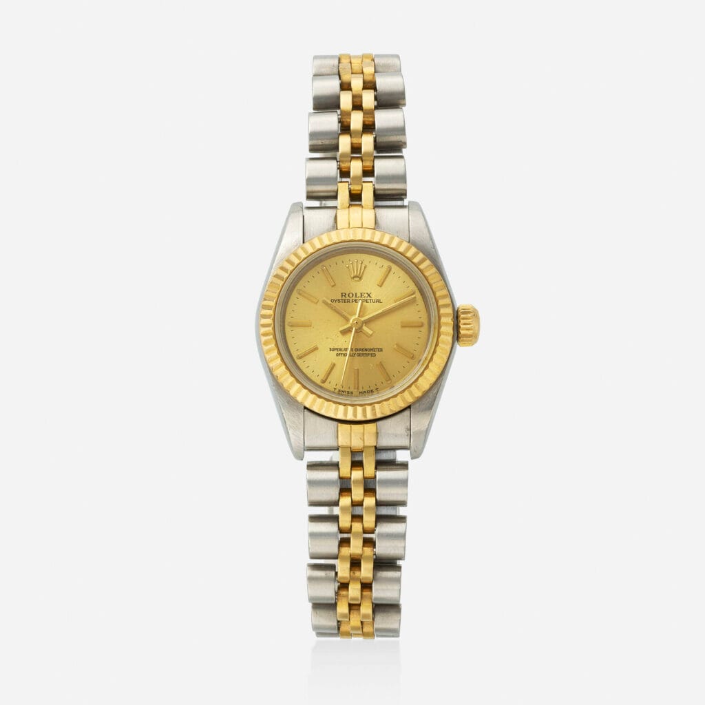 A gold and silver Rolex Oyster Perpetual wristwatch, model 67193, featuring a gold dial and a two-tone metal bracelet.