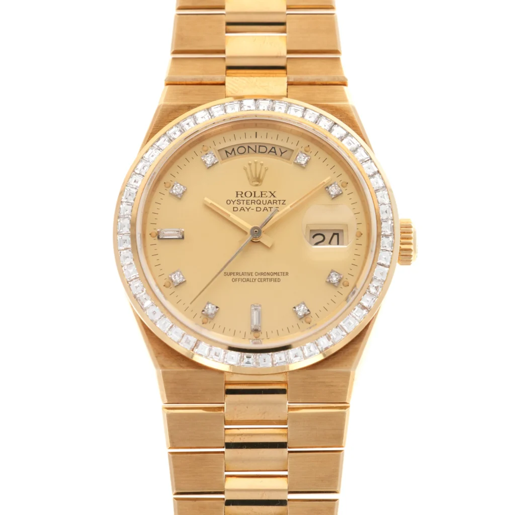 Gold Rolex Oysterquartz Day-Date 19058 watch with diamond bezel and markers, showing Monday and the 21st.