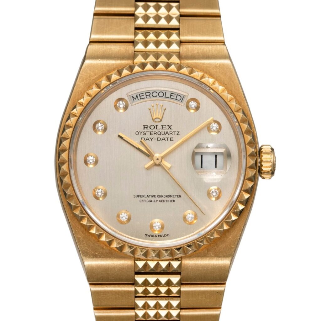Gold Rolex Oysterquartz Day-Date 19028 watch featuring diamond hour markers and an Italian day/date display.
