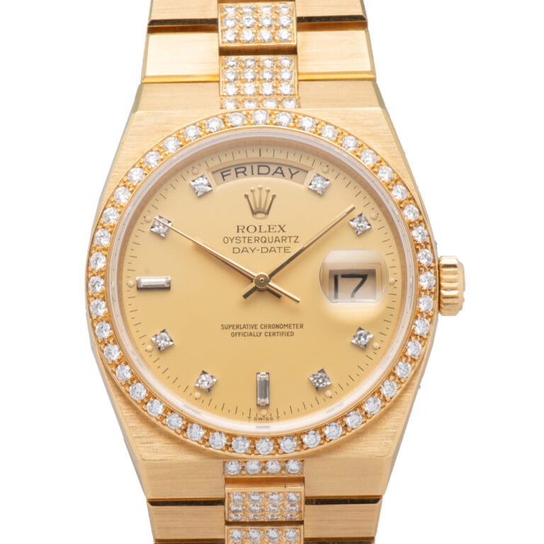 Gold Rolex Oysterquartz Day-Date 19148 watch featuring a diamond bezel, diamond hour markers, and classic day-date display.