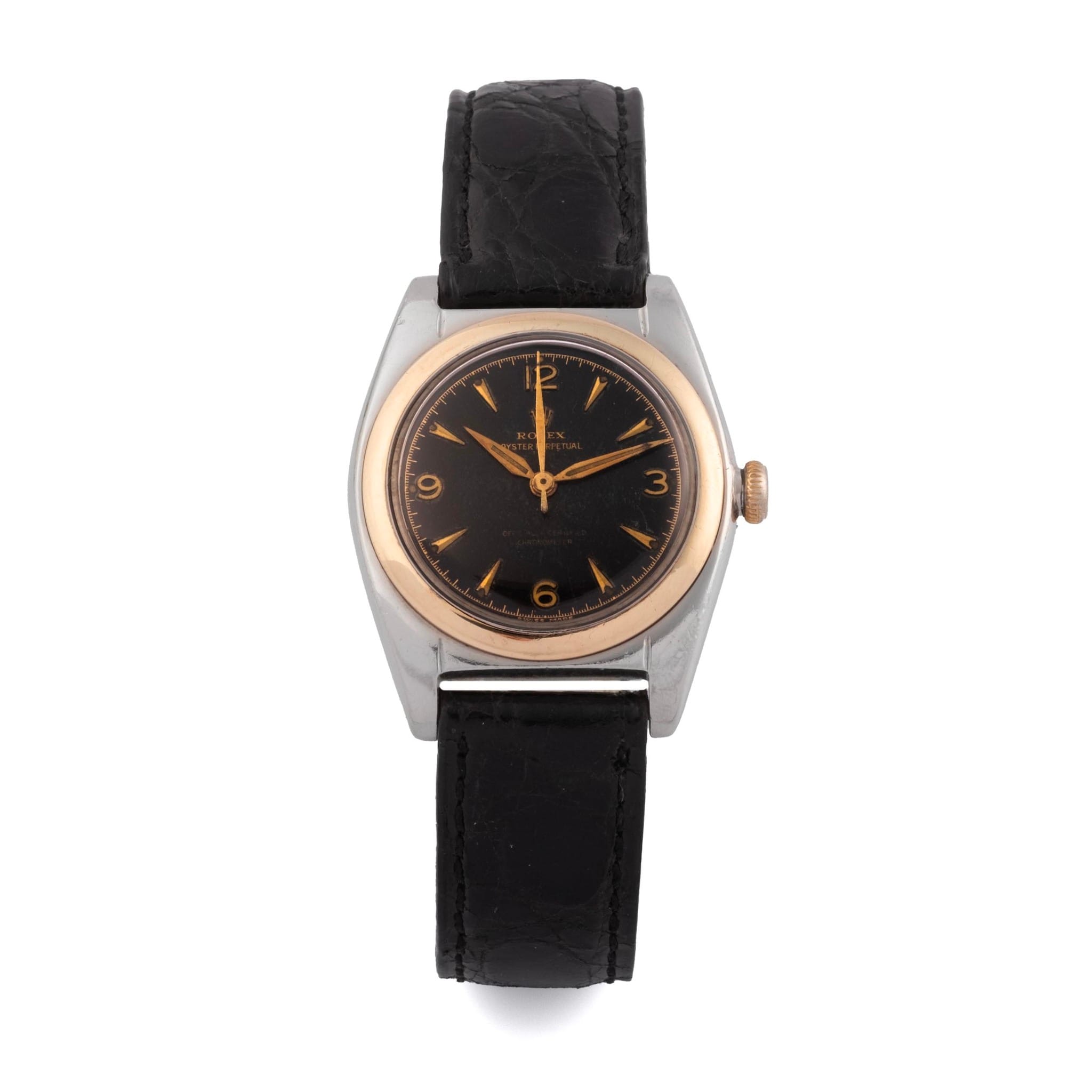 Vintage Rolex Oyster Perpetual 4937 wristwatch with a black leather strap, black dial, gold hands, and a round silver and gold casing.