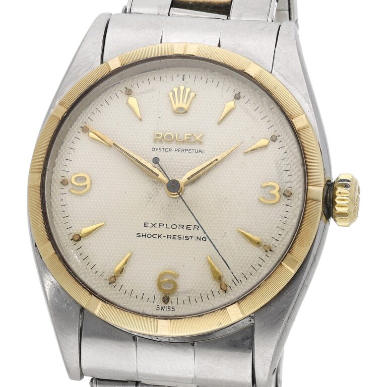 Close-up of a vintage Rolex Explorer 6299 watch with a silver and gold bezel and a metal band.