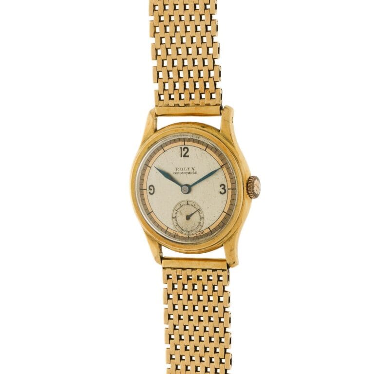 A vintage gold Rolex Oyster 3078 wristwatch with a mesh band and a small seconds subdial on a cream-colored face.