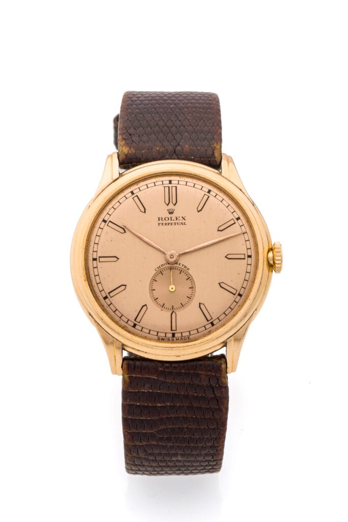 Gold vintage Rolex Oyster Perpetual wristwatch, model 4021, featuring a brown textured leather strap on a white background.
