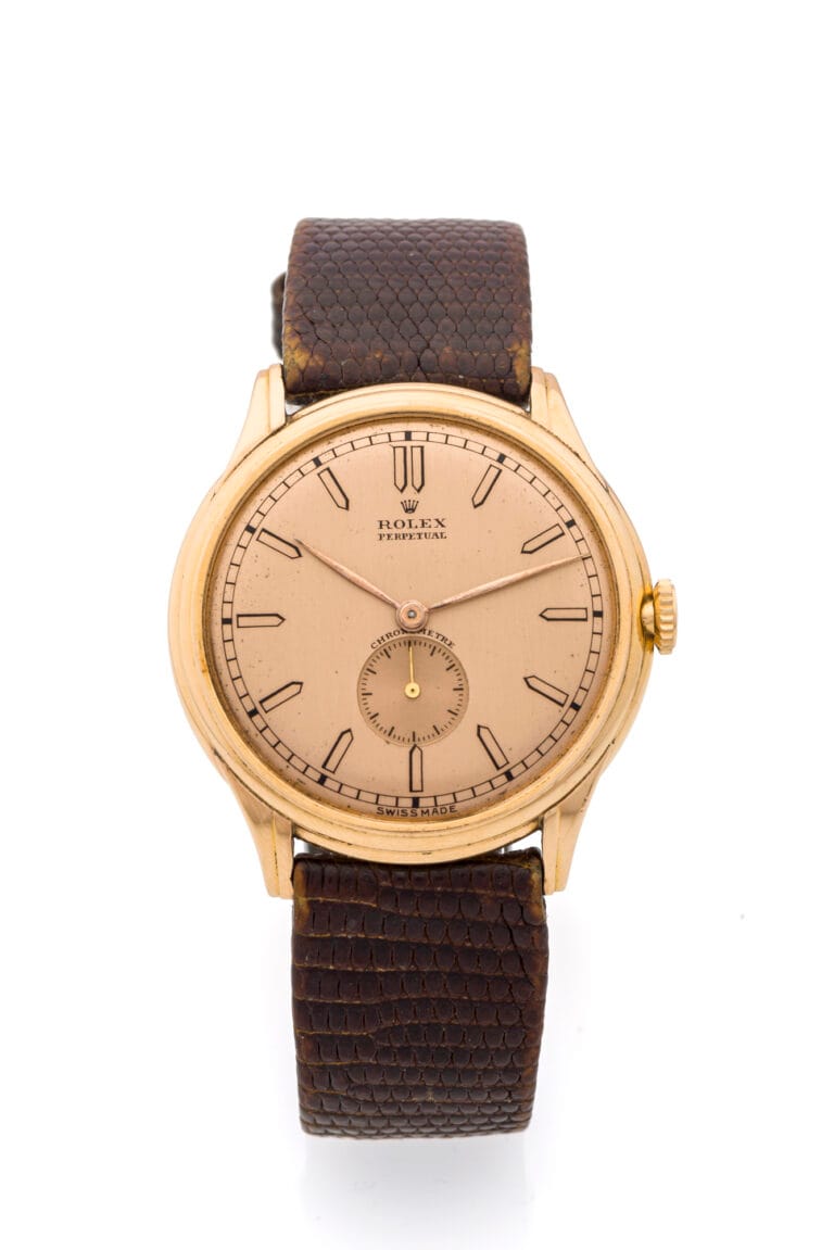 Gold vintage Rolex Oyster Perpetual wristwatch, model 4021, featuring a brown textured leather strap on a white background.