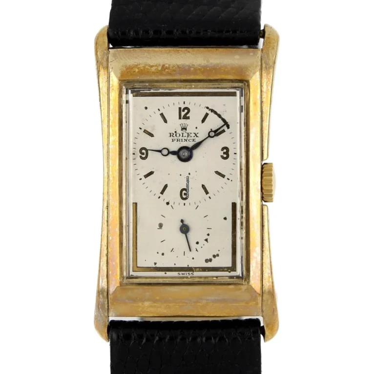 A vintage gold Rolex Prince 1871 watch with a rectangular face, black numerals, and a black leather strap.
