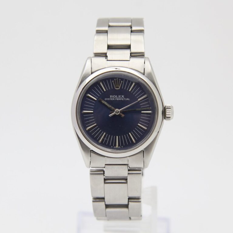 A stainless steel Rolex Oyster Perpetual 6749 watch with a dark blue dial on a metal bracelet, displayed upright.