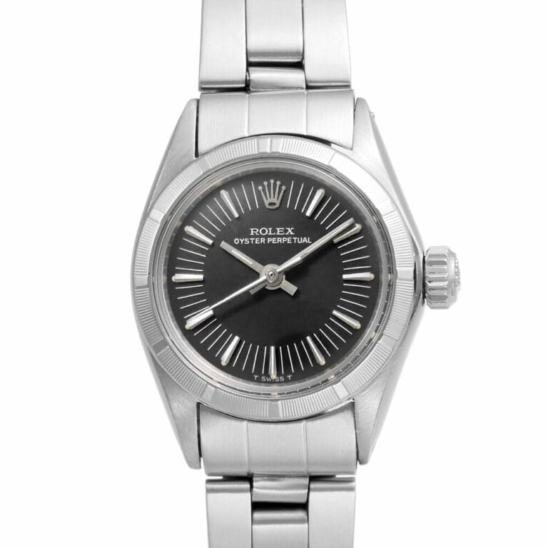 A silver Rolex Oyster Perpetual 6723 watch with a black dial and sleek silver hour markers.
