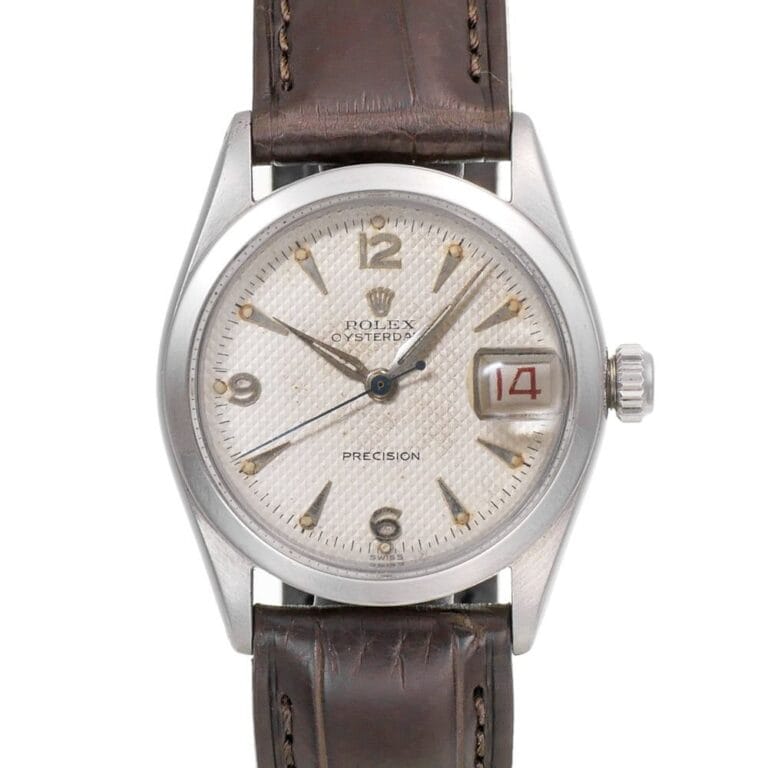 A vintage Rolex Oysterdate Precision 6266 watch with a brown leather strap and the date showing 14 in red.