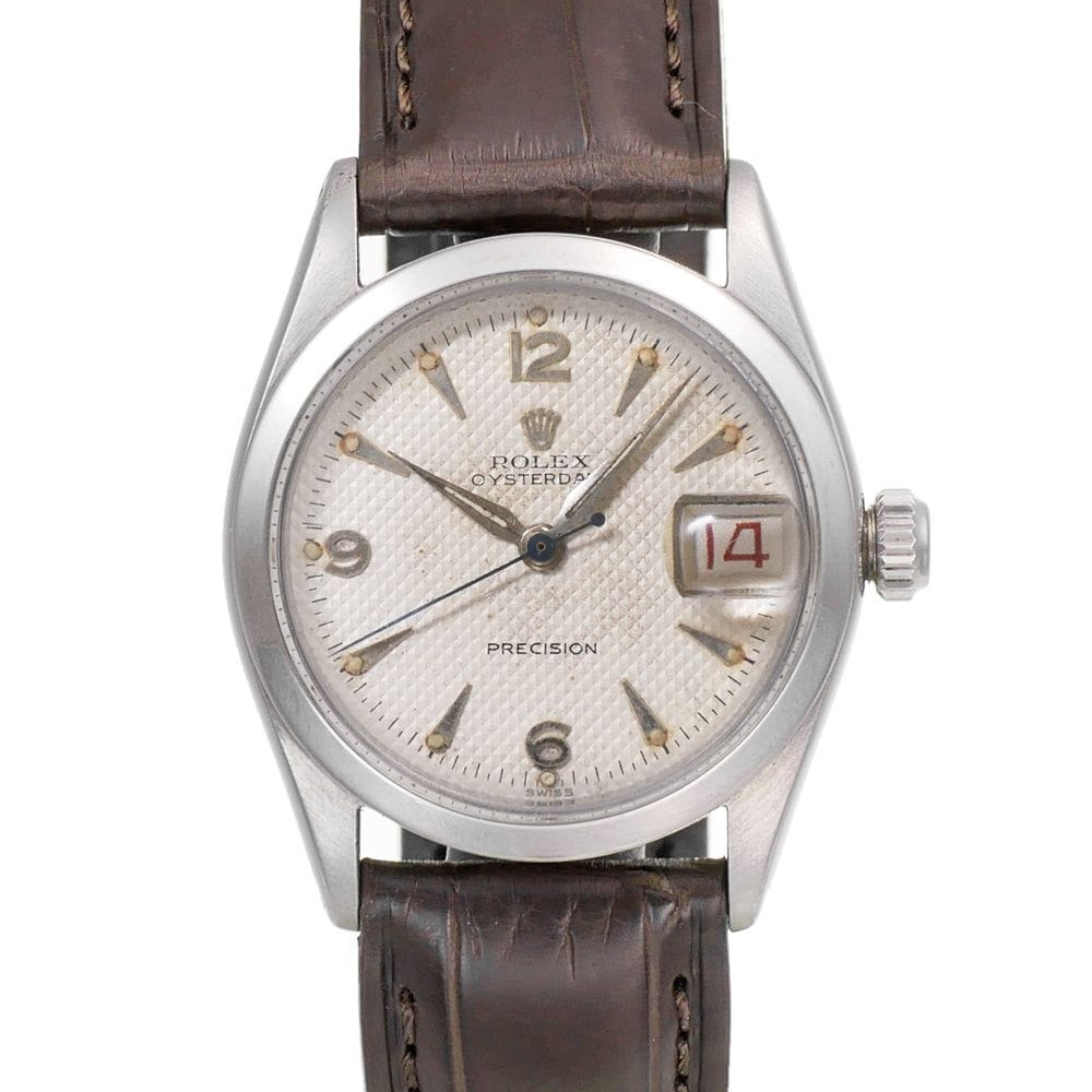 A vintage Rolex Oysterdate Precision 6266 watch with a brown leather strap and the date showing 14 in red.