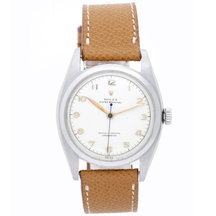A silver Rolex Explorer 6098 wristwatch with a white dial and brown leather strap, shown from the front.
