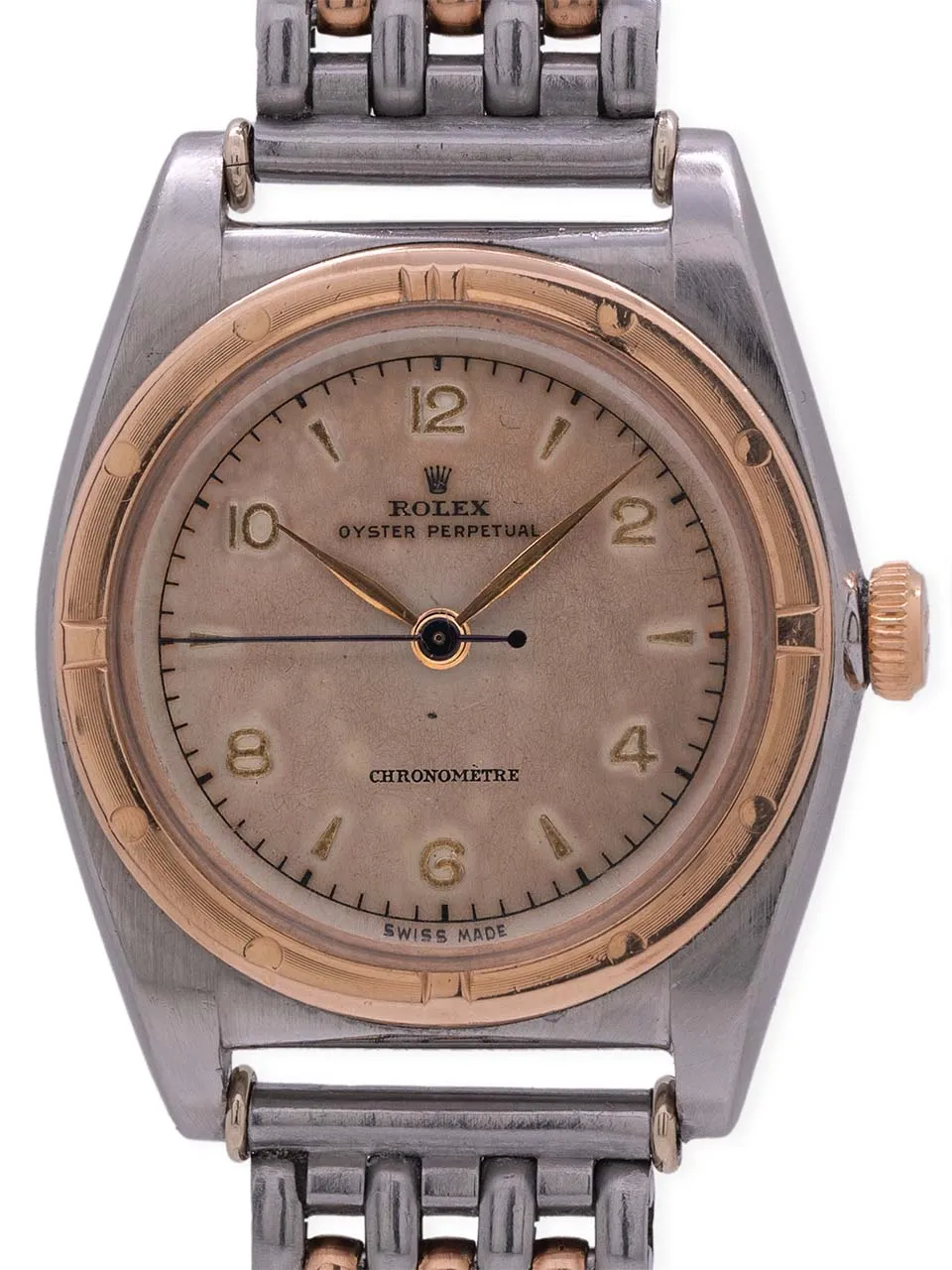 A vintage Rolex Oyster Perpetual 3272 watch with a two-tone metal case and bracelet, displaying gold hour markers.