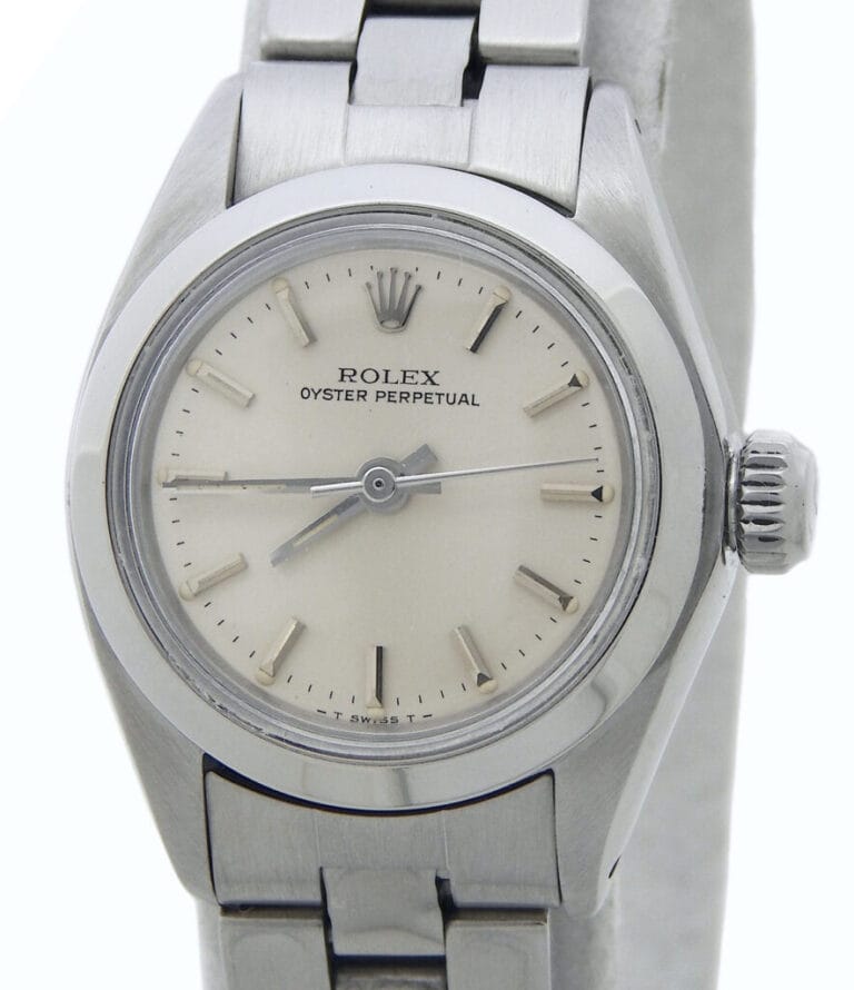 Close-up of a silver Rolex Oyster Perpetual 6718 watch with a white dial and metal link bracelet.
