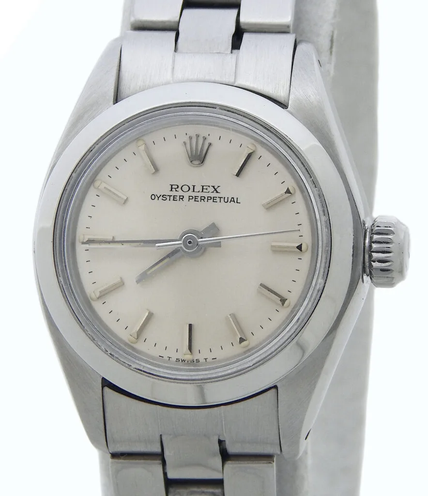 Close-up of a silver Rolex Oyster Perpetual 6718 watch with a white dial and metal link bracelet.
