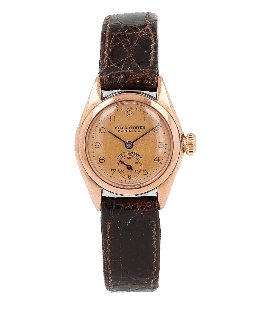 A vintage Rolex Oyster Perpetual 3869 watch featuring a brown leather strap and a gold-toned face.