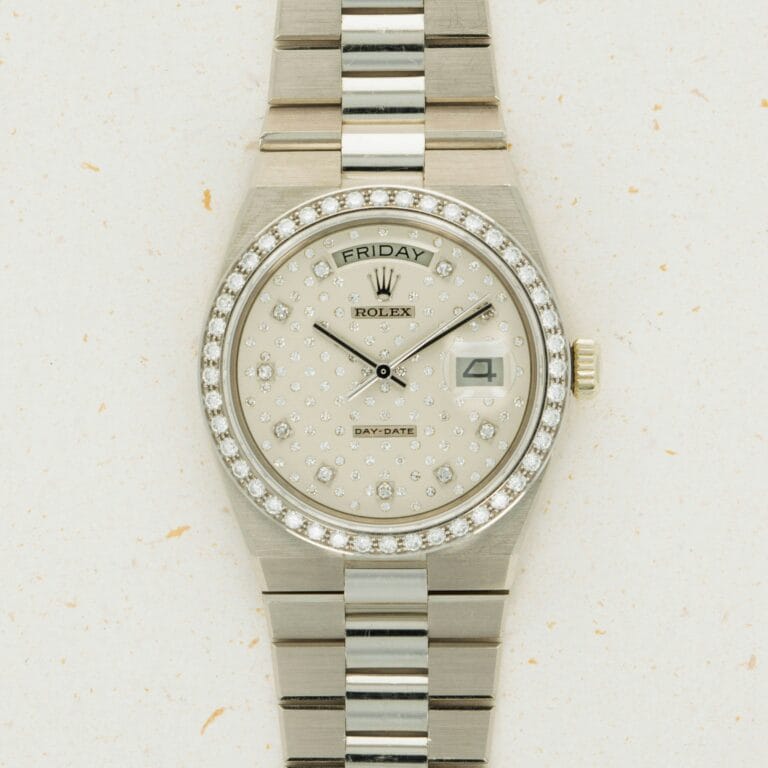 Silver Rolex Oysterquartz Day-Date watch with a diamond-studded face, day and date displays, and a two-tone metal bracelet.