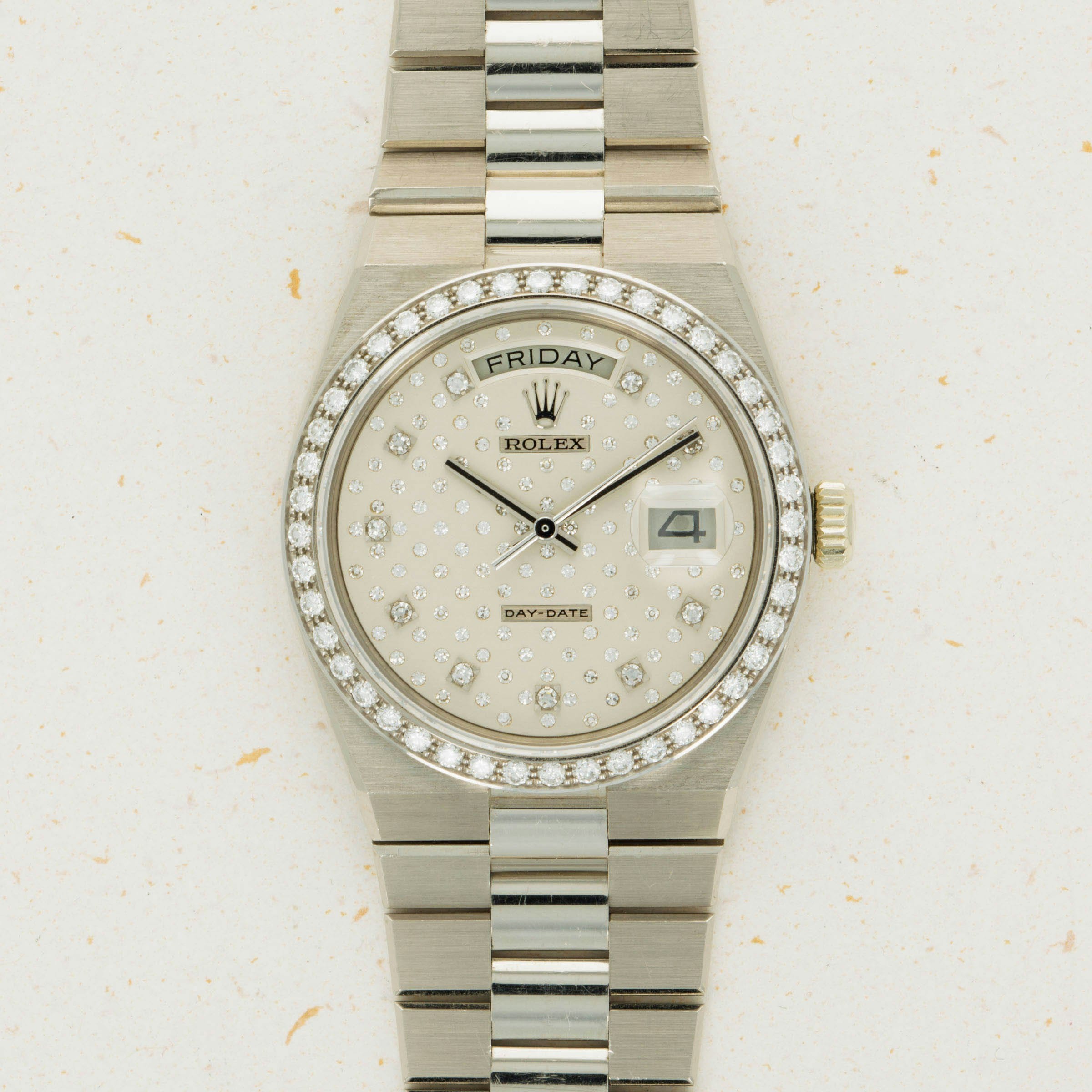 Silver Rolex Oysterquartz Day-Date watch with a diamond-studded face, day and date displays, and a two-tone metal bracelet.